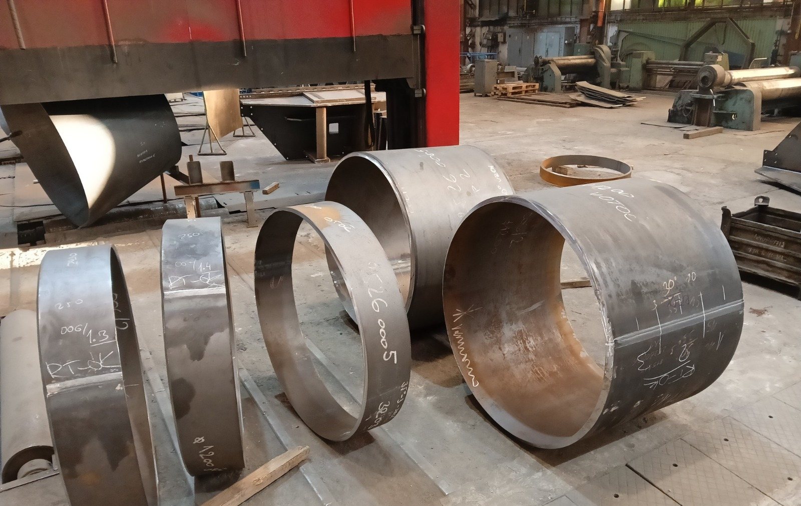 Rolled heat exchanger shell courses with chalk marks recording accepted radiography
