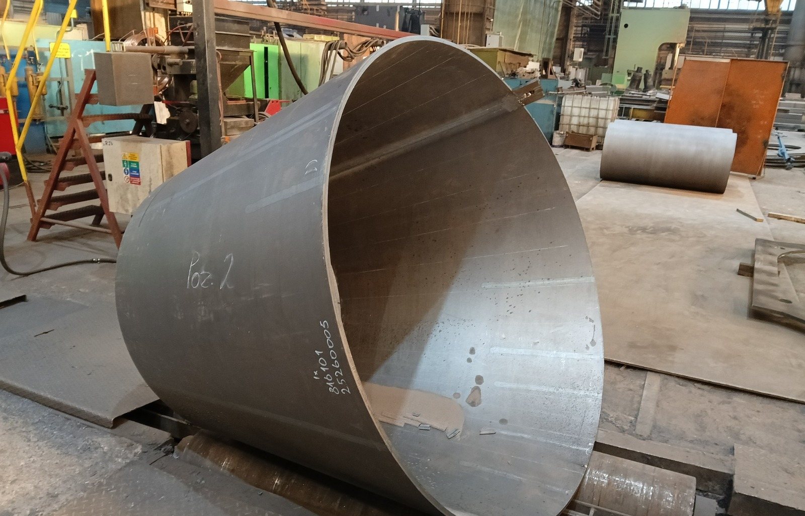 Rolled conical transition section for a heat exchanger shell